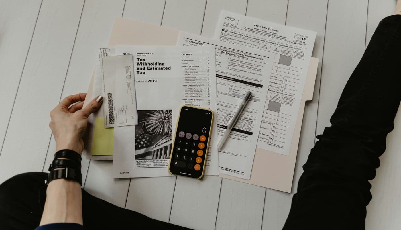 Tax forms, a pen and a calculator