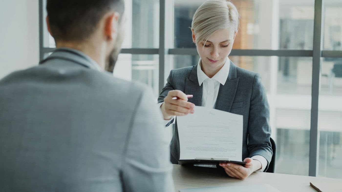 A Necomitt advisor reviewing documents with a client